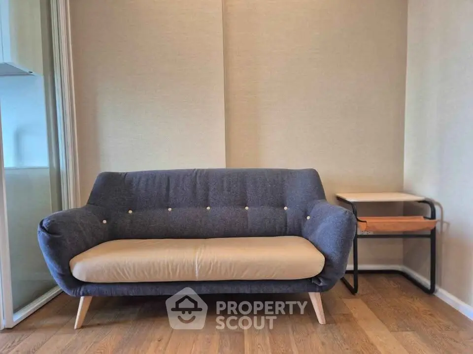 Stylish modern living room with cozy sofa and wooden side table, perfect for relaxation.