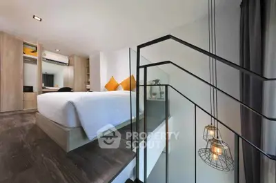 Modern bedroom with stylish lighting and wooden flooring, featuring a cozy bed and elegant decor.