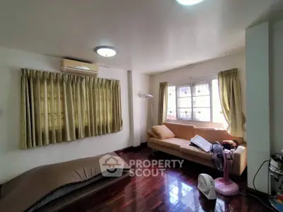 Spacious living room with hardwood floors and cozy seating area