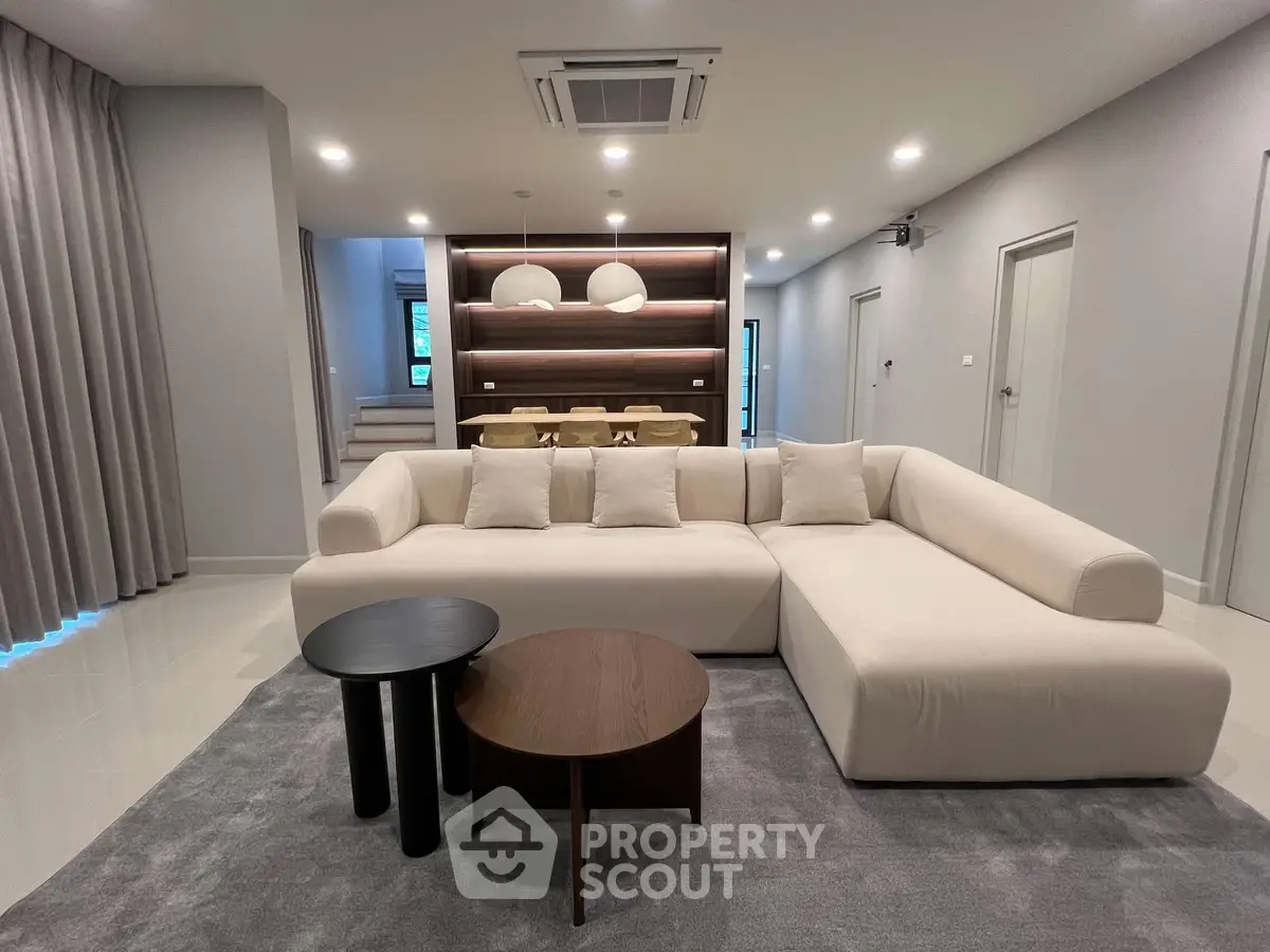 Spacious modern living room with elegant sectional sofa and stylish decor