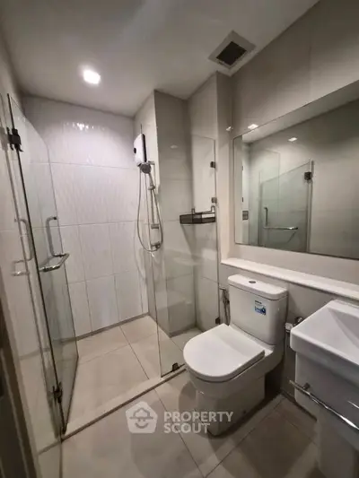 Modern bathroom with glass shower and sleek fixtures