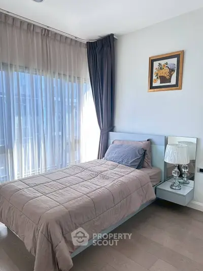 Cozy bedroom with elegant decor and large windows for natural light