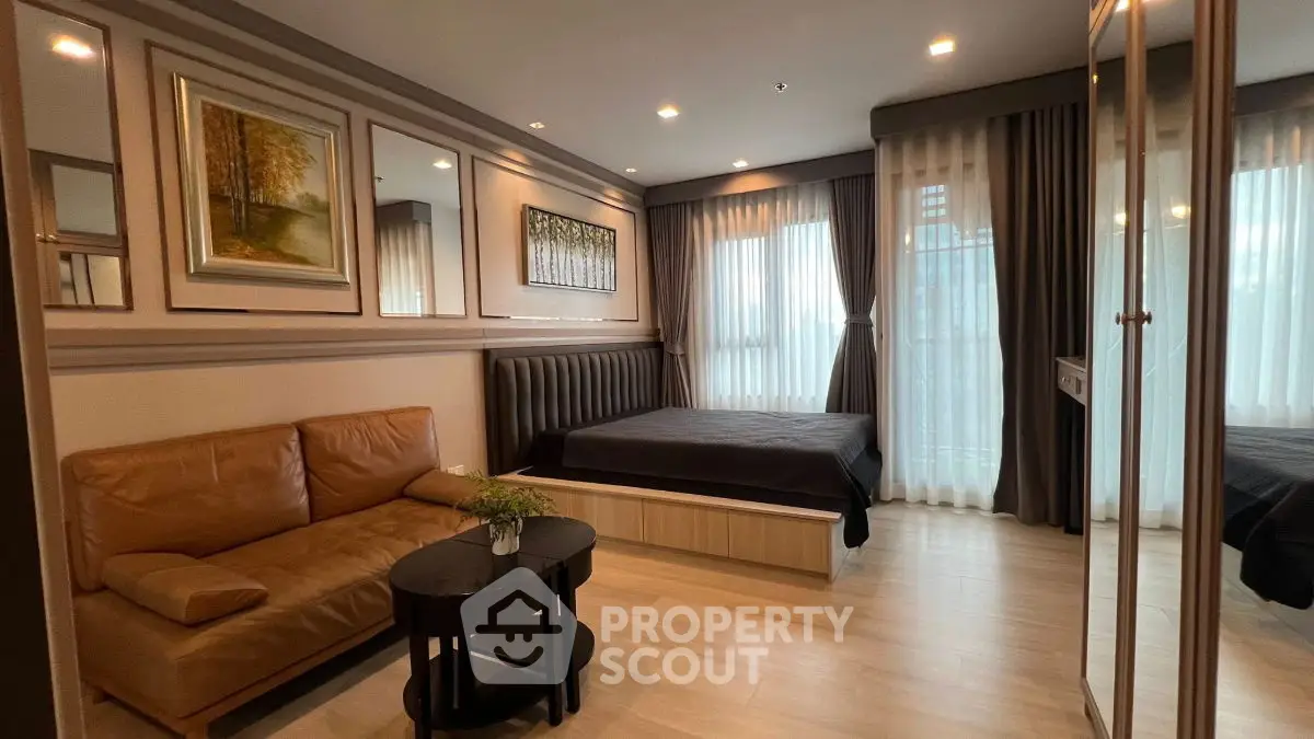 Modern bedroom with cozy seating area and elegant decor