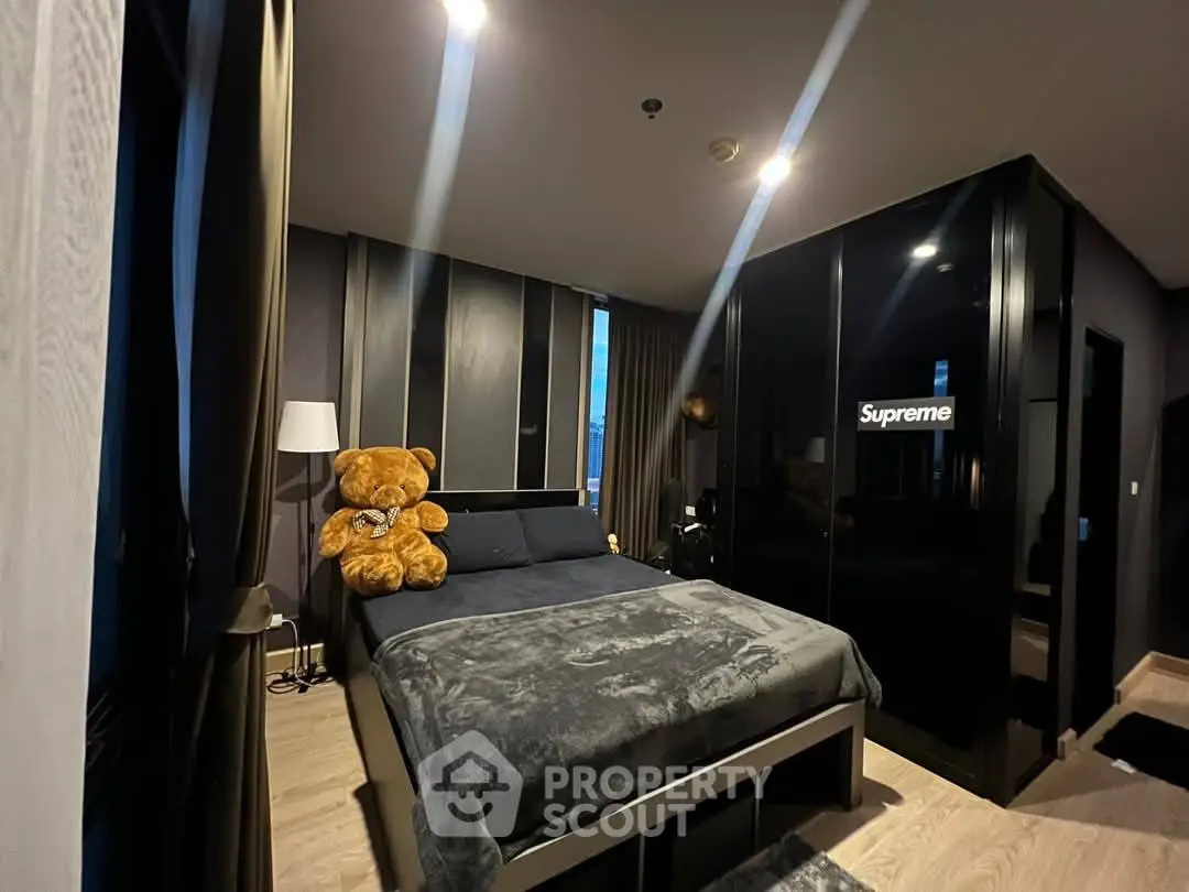 Modern bedroom with stylish decor and plush teddy bear on bed