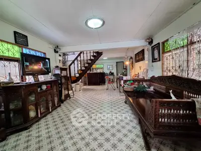 Charming vintage living room with intricate wooden furniture and patterned tile flooring.