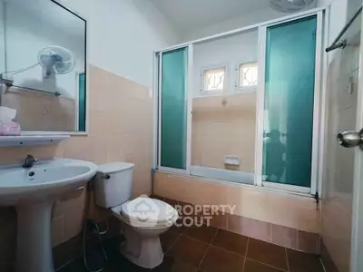Cozy bathroom with modern fixtures and frosted glass shower enclosure.