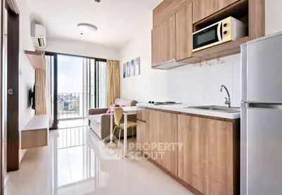 Modern open-layout kitchen and living room with city view balcony in a stylish apartment.