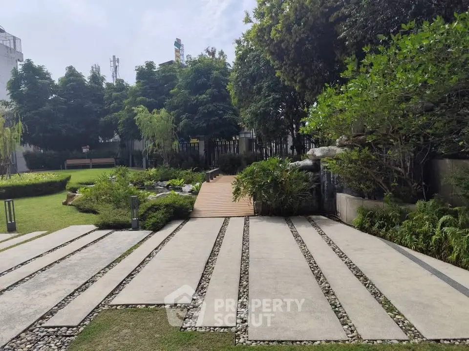 Serene garden pathway with lush greenery and modern landscaping.