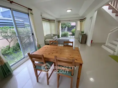 Spacious living room with dining area and garden view, perfect for family gatherings.