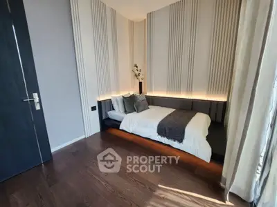 Modern bedroom with stylish lighting and wooden flooring