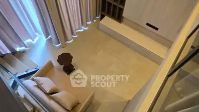 Modern living room with cozy sofa and elegant curtains, perfect for relaxation and entertainment.