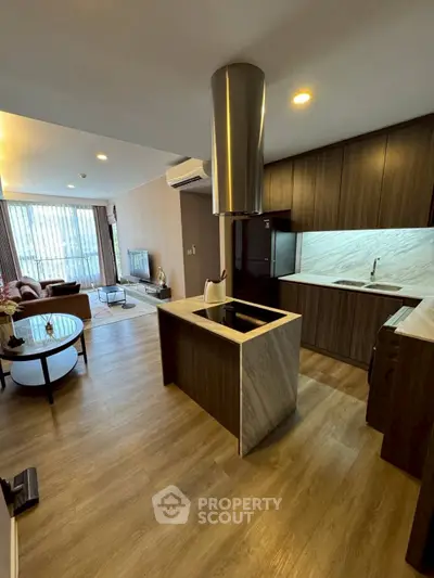 Modern open-layout kitchen and living room with sleek design and natural light