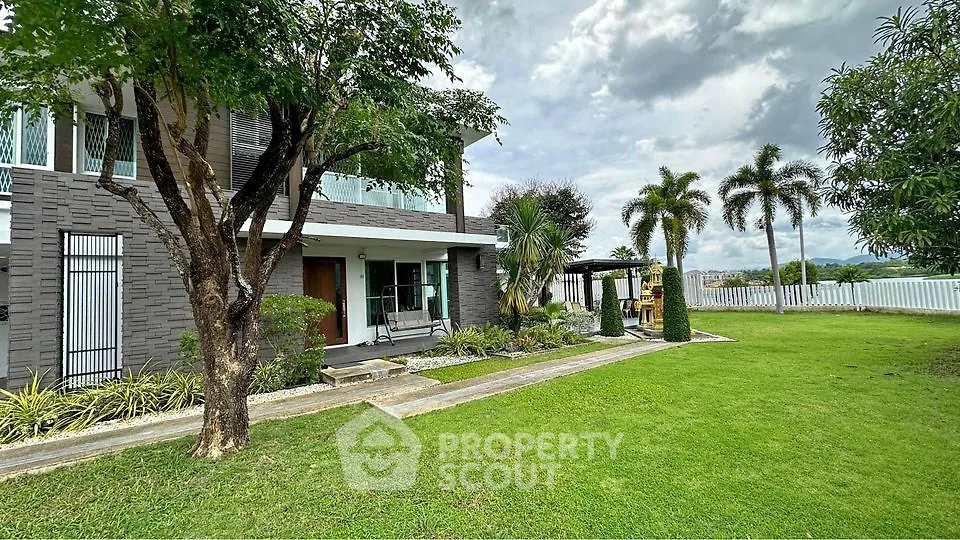Stunning modern home with lush garden and spacious lawn, perfect for outdoor living.