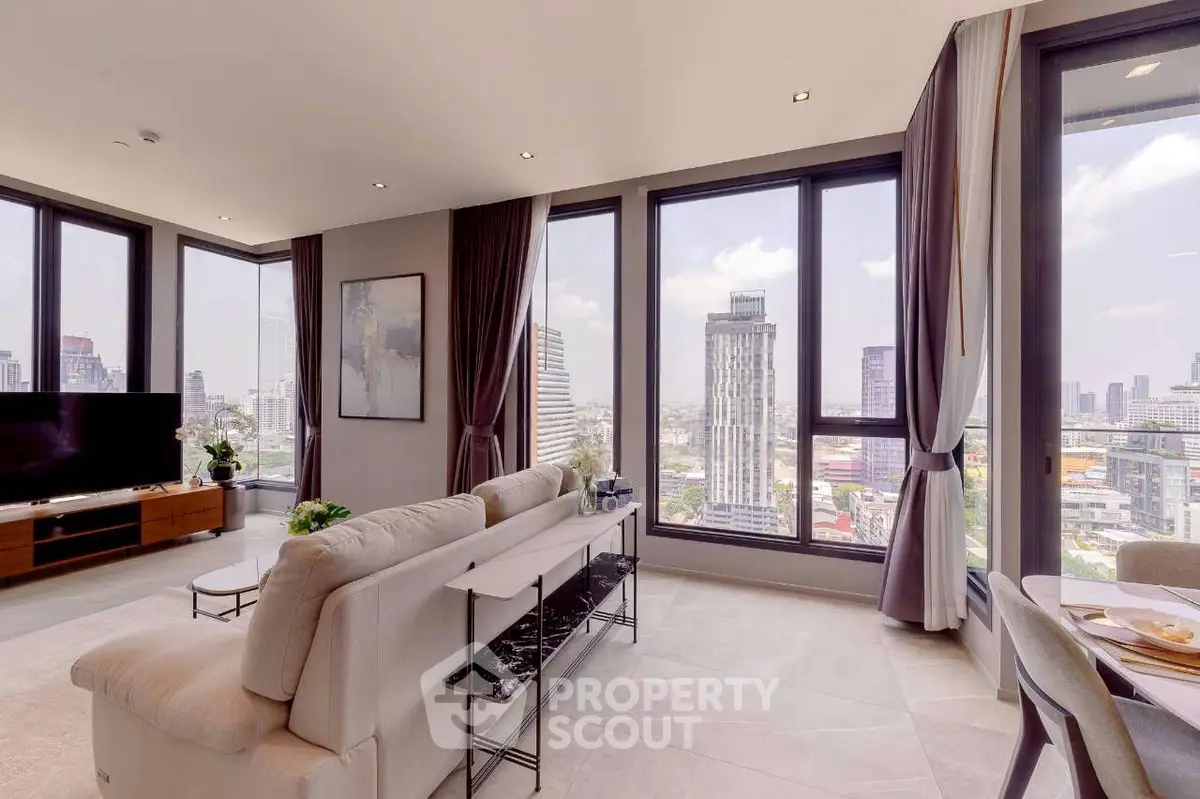 Luxurious corner unit living room with panoramic city views and modern decor.
