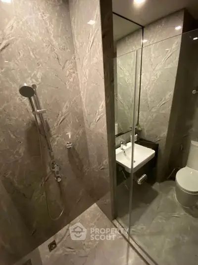 Luxurious marble bathroom with modern shower and sleek fixtures