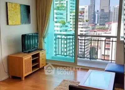 Modern living room with city view and balcony access in high-rise apartment.