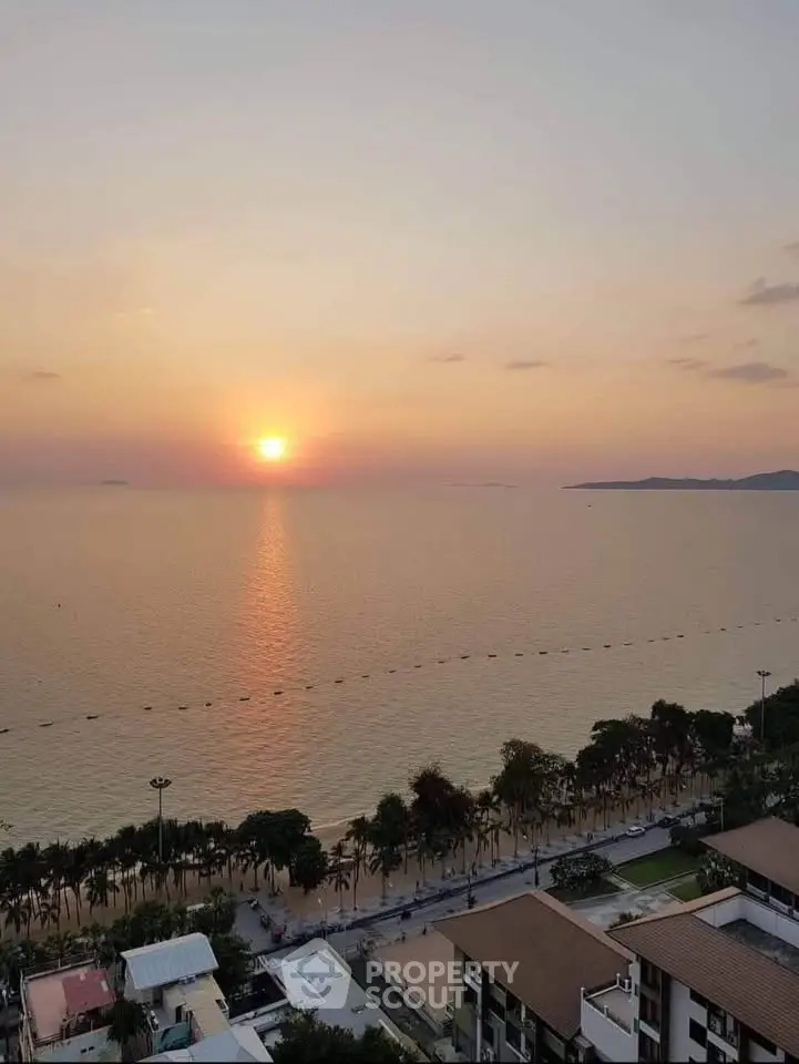 Stunning beachfront view at sunset from a high-rise apartment, perfect for serene living.