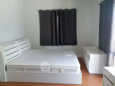 Minimalist bedroom with white furniture and dark curtains