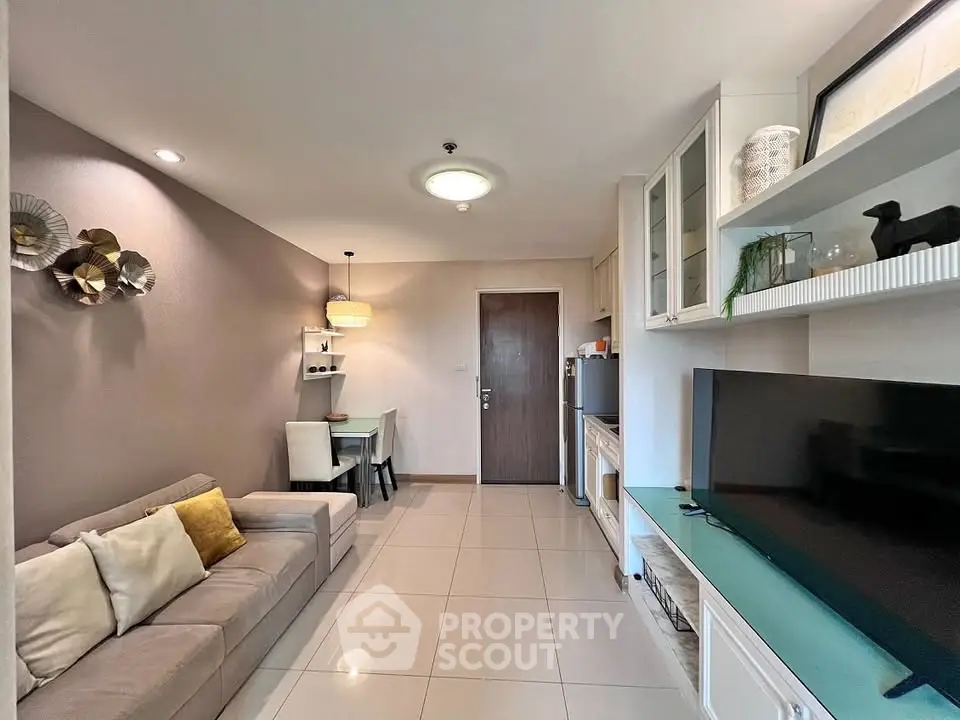 Modern living room with stylish decor and open layout, featuring a cozy sofa and dining area.