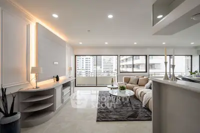 Luxurious modern living room with elegant decor and city view balcony.