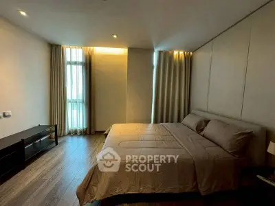 Spacious modern bedroom with elegant decor and natural light