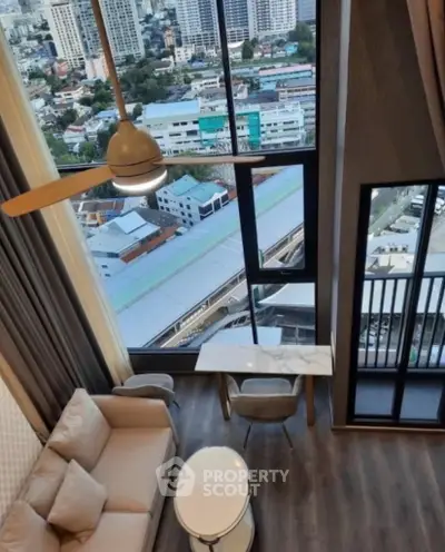 Stunning high-rise living room with floor-to-ceiling windows and breathtaking city views.