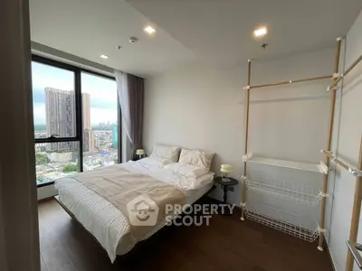 Modern bedroom with city view and minimalist decor in high-rise apartment