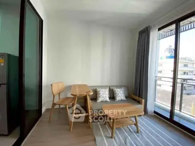 Modern living room with stylish furniture and balcony view in a bright apartment.