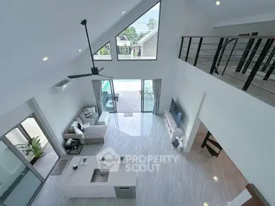 Stunning modern living room with high ceilings and mezzanine overlooking pool