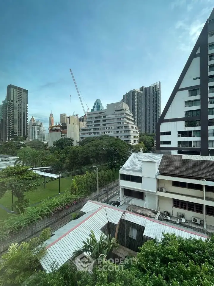 Stunning cityscape view showcasing modern architecture and lush greenery, perfect for urban living enthusiasts.
