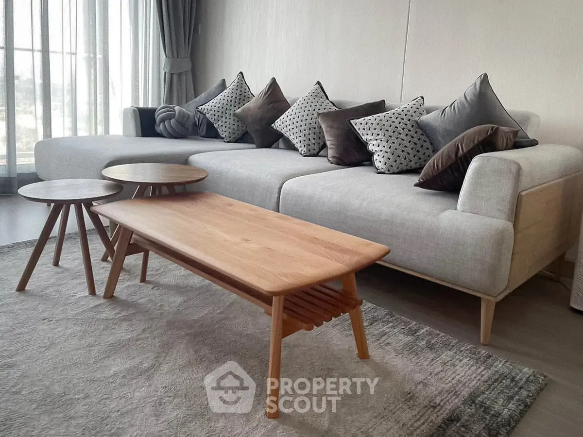 Stylish modern living room with cozy sofa and chic wooden coffee tables