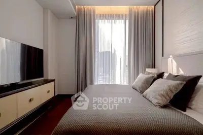 Modern bedroom with elegant decor and large window for natural light