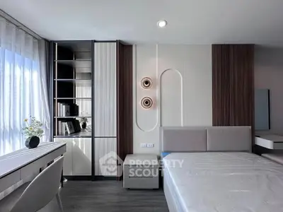 Modern bedroom with sleek design, featuring a stylish bed, built-in shelves, and elegant lighting.