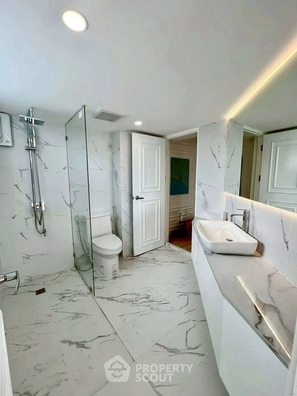 Luxurious modern bathroom with marble tiles and sleek fixtures in a high-end property.