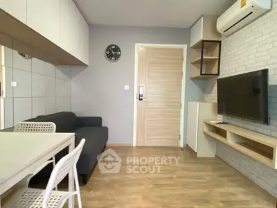 Modern living room with sleek furniture and wall-mounted TV in a stylish apartment.