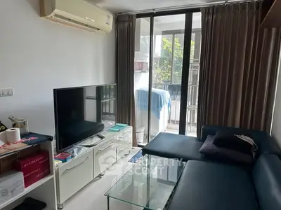 Modern living room with sleek furniture and balcony view, perfect for urban living.