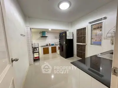 Spacious kitchen with modern appliances and sleek design, perfect for culinary enthusiasts.