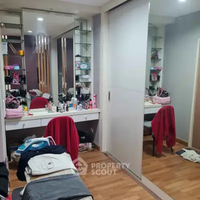 Spacious bedroom with mirrored wardrobe and vanity area, perfect for modern living.