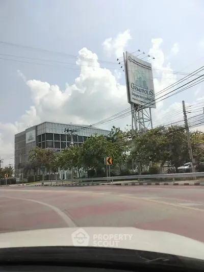 Modern commercial building with large billboard in urban setting, ideal for business opportunities.