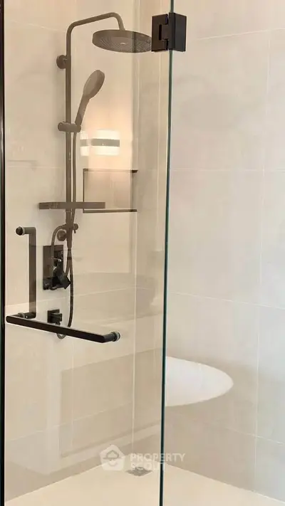 Modern bathroom shower with glass enclosure and sleek fixtures.