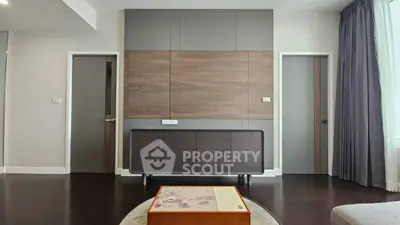 Modern living room with sleek wooden paneling and stylish furniture