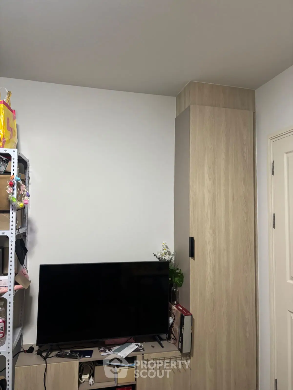 Cozy living room with modern TV setup and wooden storage unit