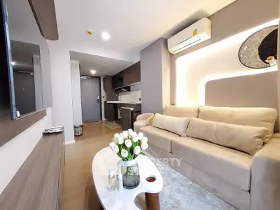 Modern living room with cozy beige sofa and stylish decor in a contemporary apartment.