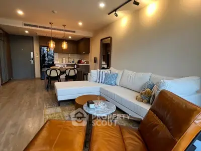 Modern living room with stylish furniture and open kitchen layout