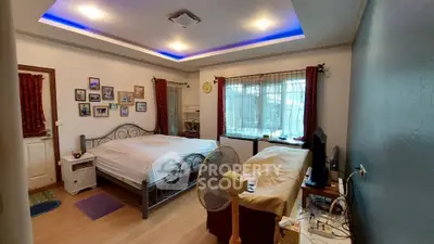Spacious bedroom with ambient lighting, large windows with curtains, and ample space for personalization in a cozy home setting.