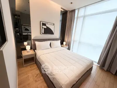 Modern bedroom with large windows and stylish decor in a high-rise apartment.
