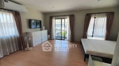 Spacious bedroom with balcony access and modern furnishings