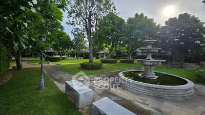 Serene garden with fountain and lush greenery in a residential complex