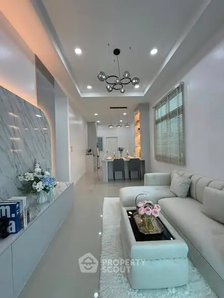 Modern living room with elegant decor and open kitchen layout