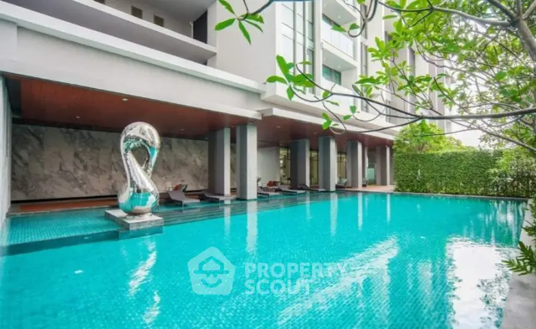 Luxurious residential pool area with modern design and lush greenery